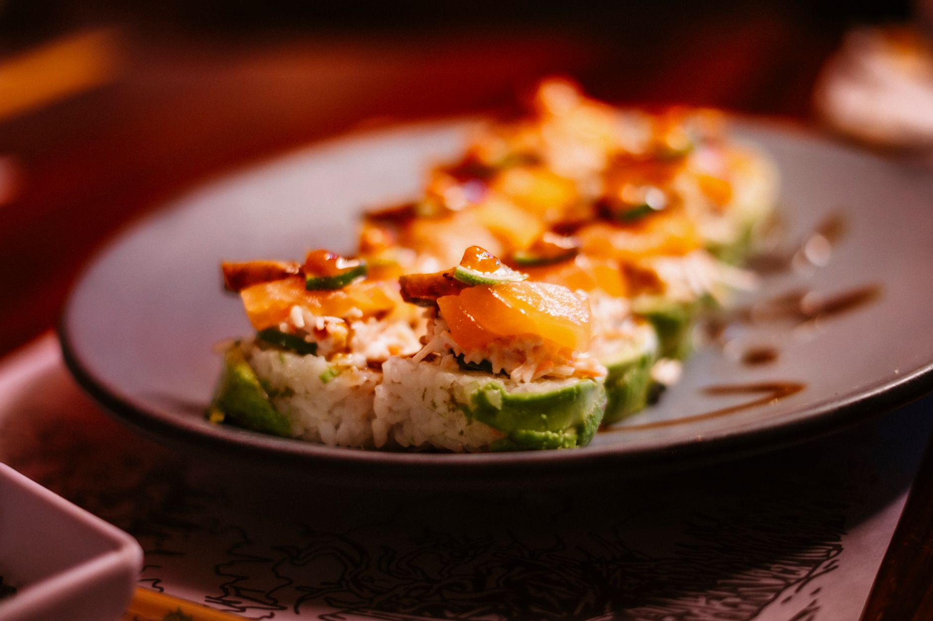 Fresh sushi rolls with salmon and avocado on a plate
