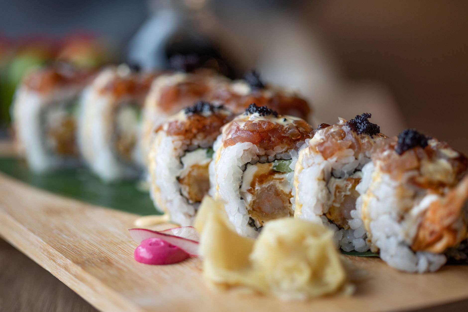 Assorted sushi rolls served on a wooden board