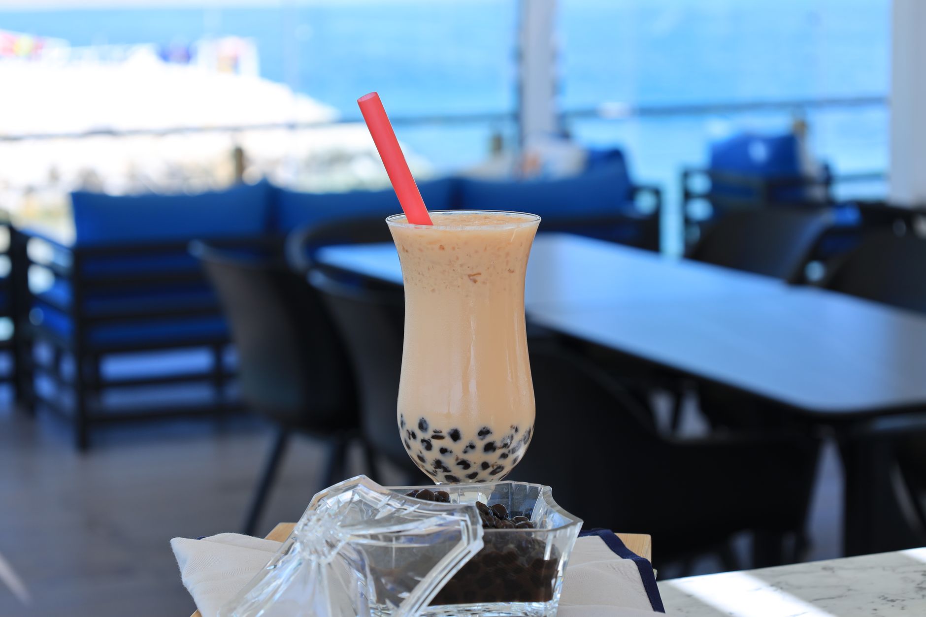 Chilled boba tea with tapioca pearls and a straw