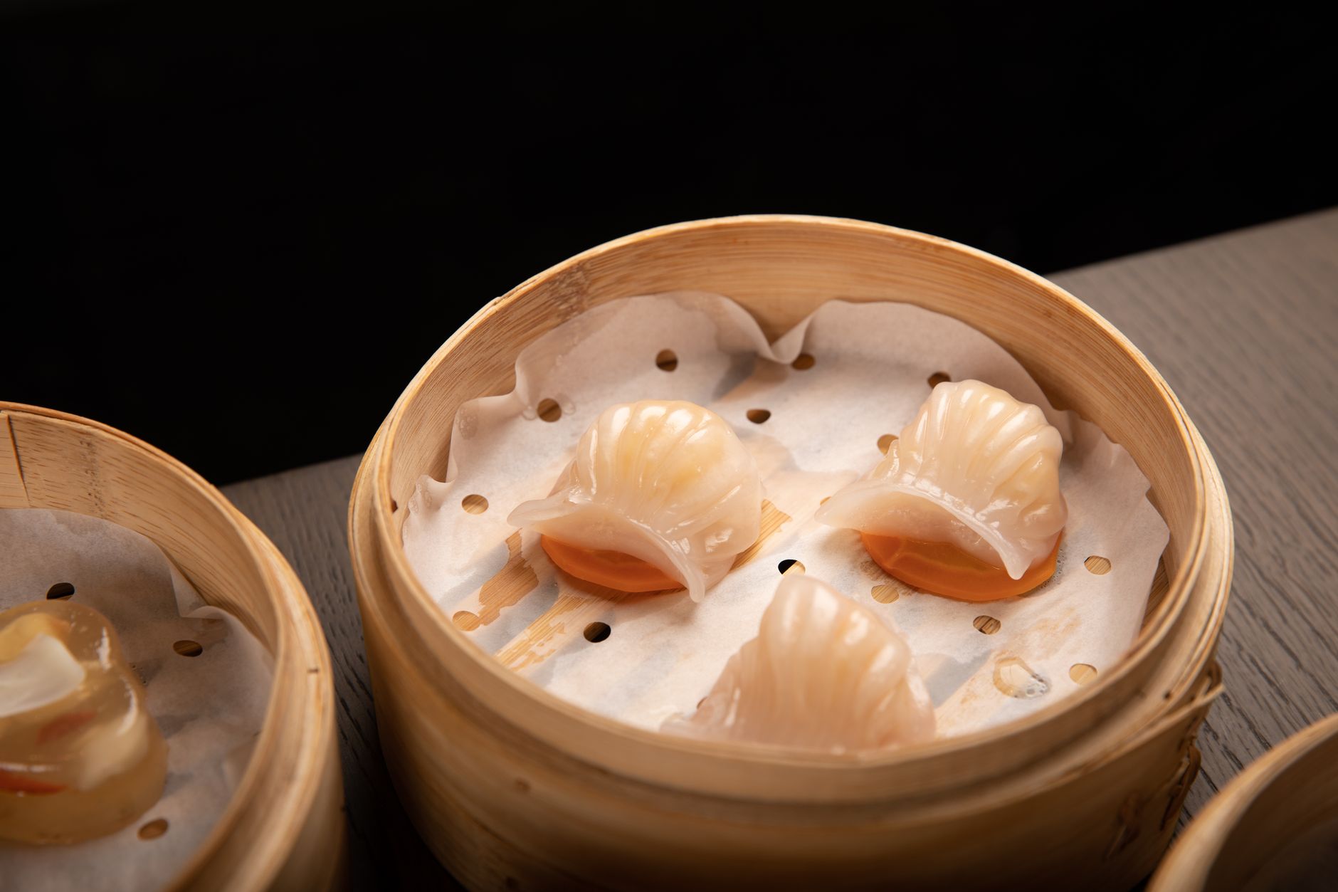 Steamed shrimp dumplings in a bamboo dim sum basket