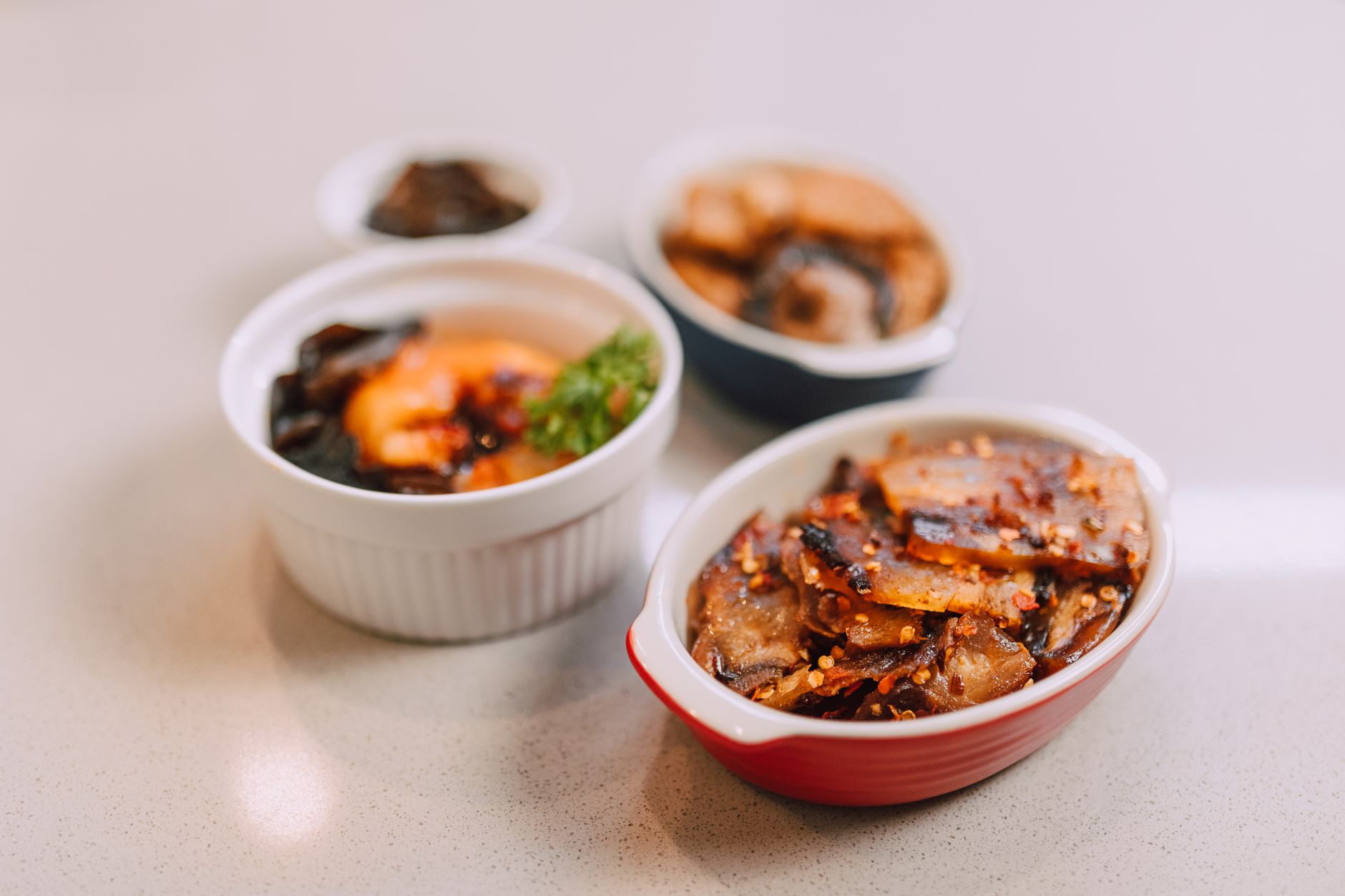 Assorted Korean banchan side dishes in small ceramic bowls