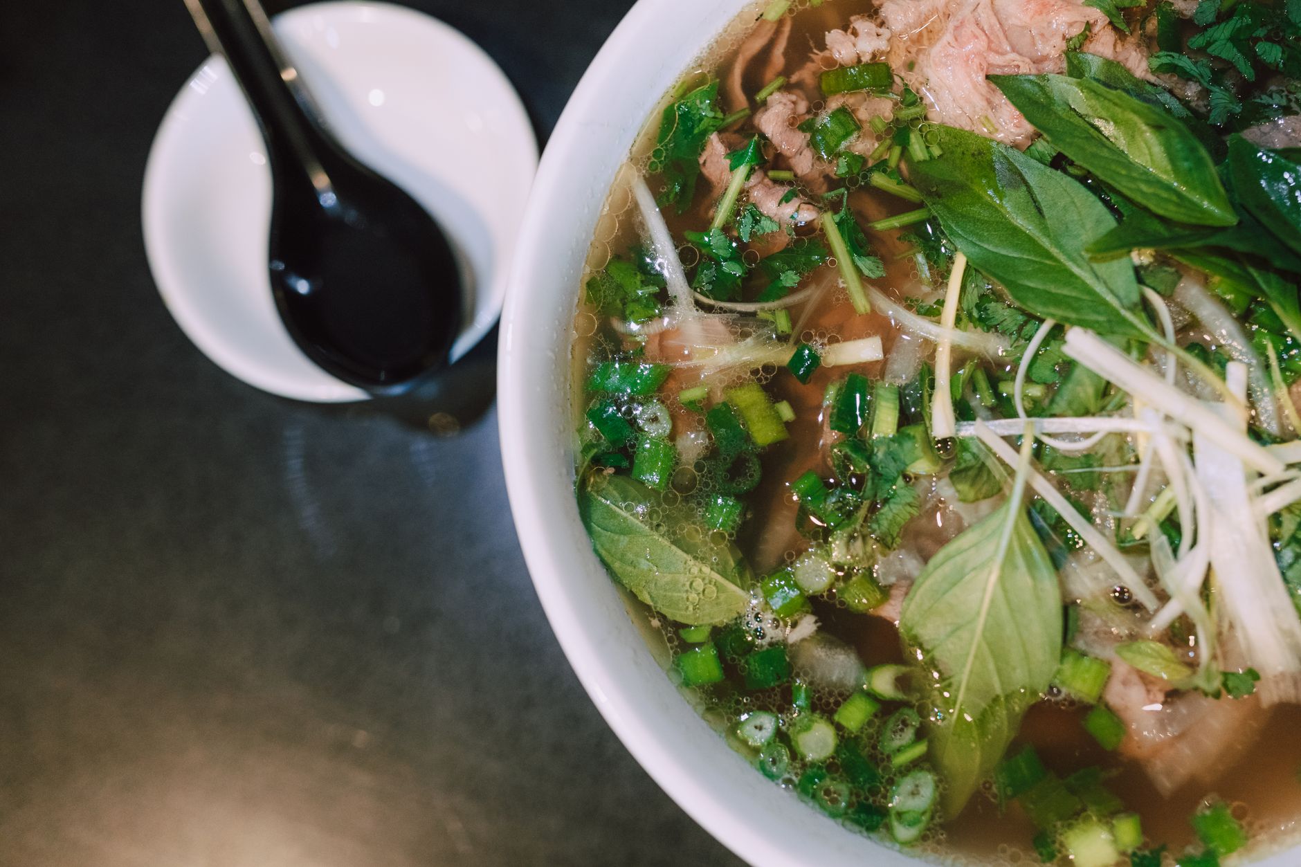 Traditional Vietnamese pho soup with fresh herbs and toppings